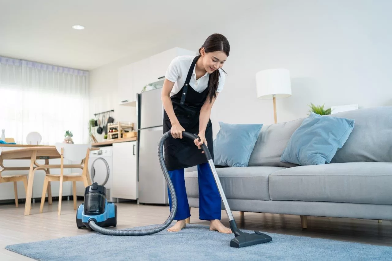 cleaning service woman worker cleaning in living room at home.