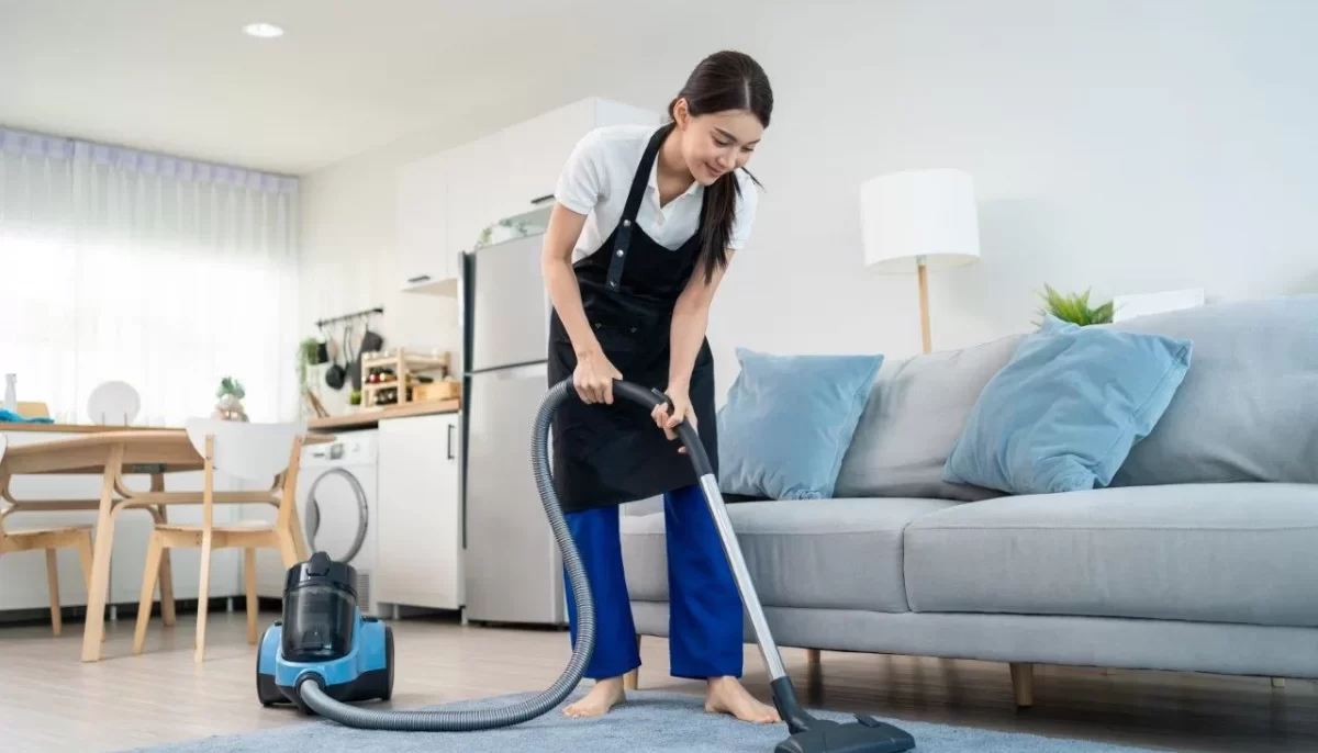 cleaning service woman worker cleaning in living room at home.